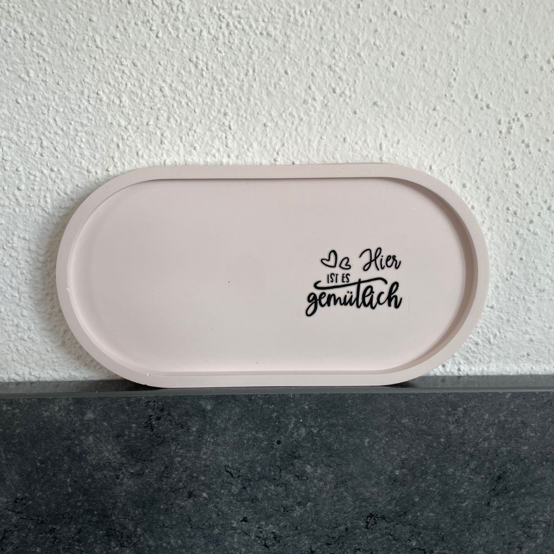 Ovale Platte in Zartrosa mit Sticker "Hier ist es gemütlich"